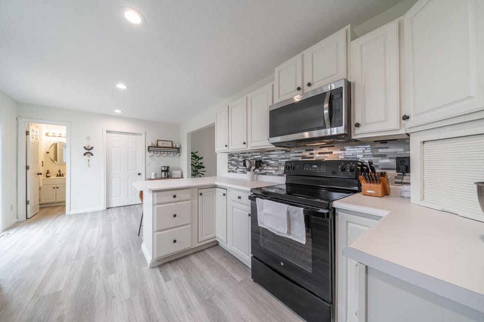 The kitchen is well stocked with pots, pans, utensils, crock pot, griddle.