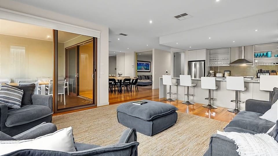 The main living area has a fantastic open kitchen with loads of counter space and highball stools to gather around while meals are being prepared.
