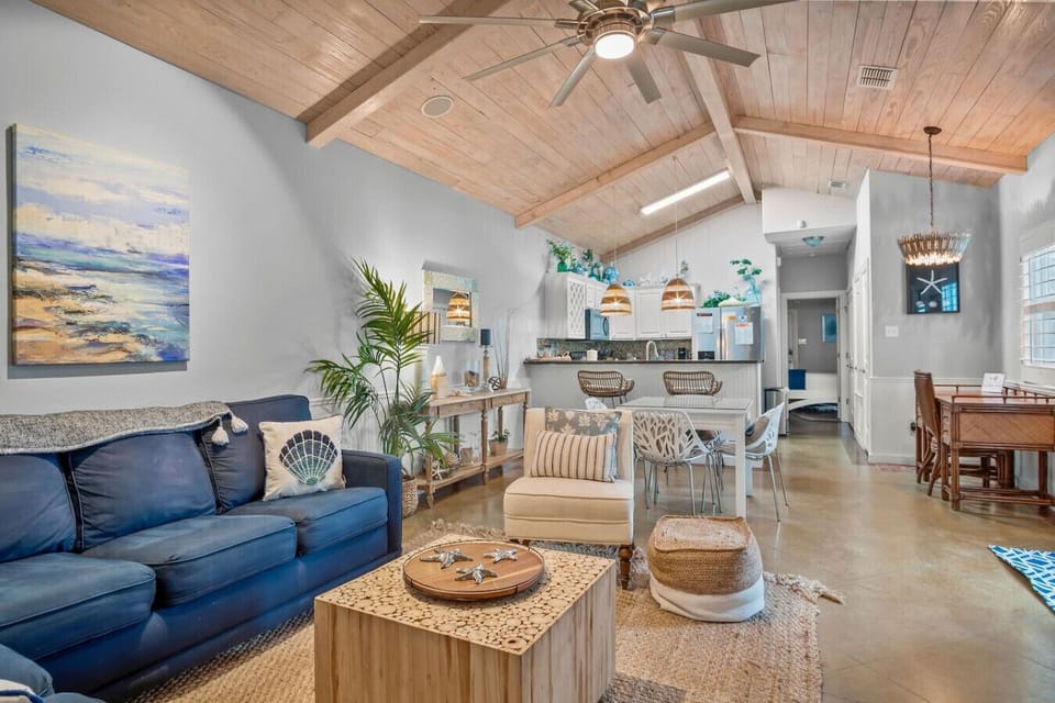 Bright & Airy Living Space with Vaulted Wood Ceilings and Cozy Seating