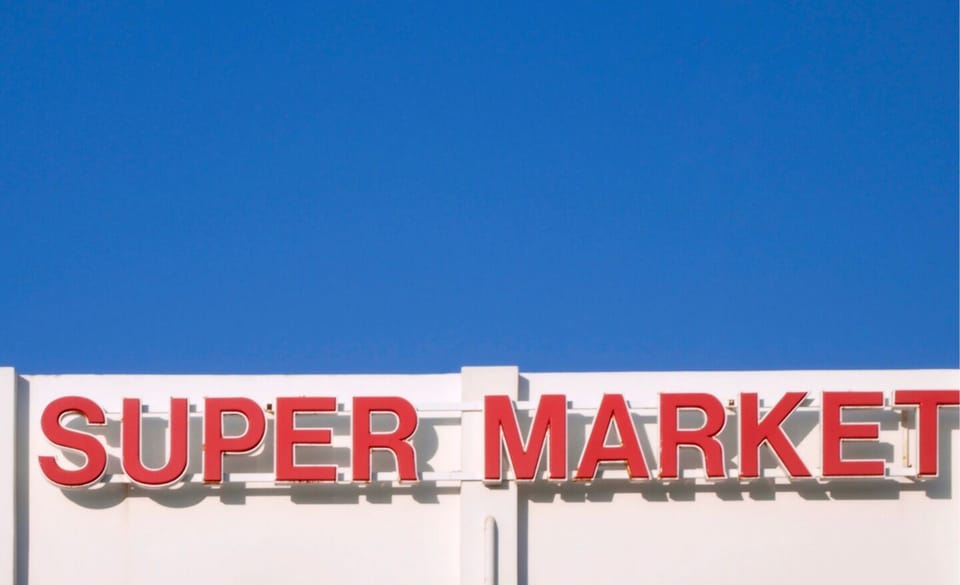 Nearby, a large supermarket