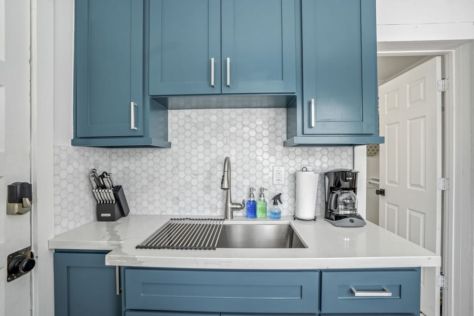 Fully stocked kitchen with all appliances and utensils.