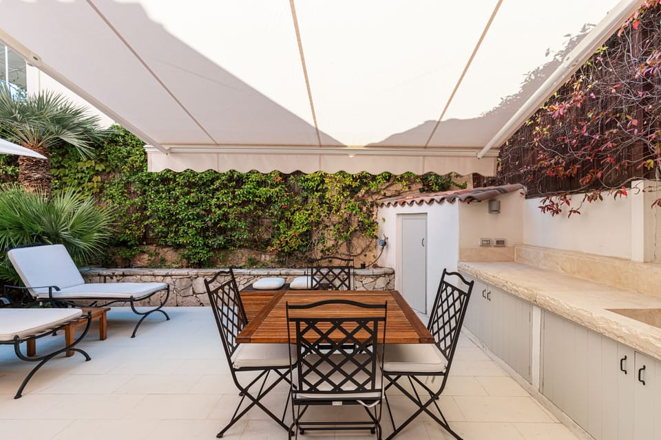 The dining area with its own sun awning by day and candles by night.