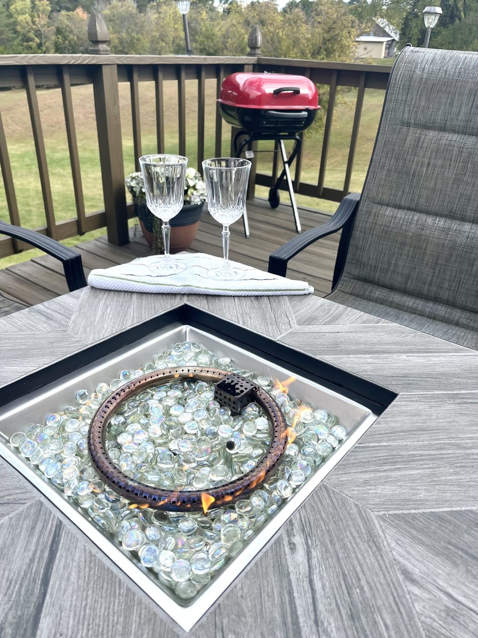 Gas firepit with seating for four along with charcoal grill for outdoor dining