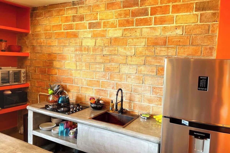 A full kitchen with 4-burner gas stovetop. Note there is no oven. But, we do supply a toaster oven.