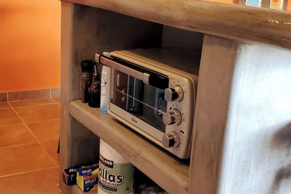 Toaster oven and additional supplies in the center island