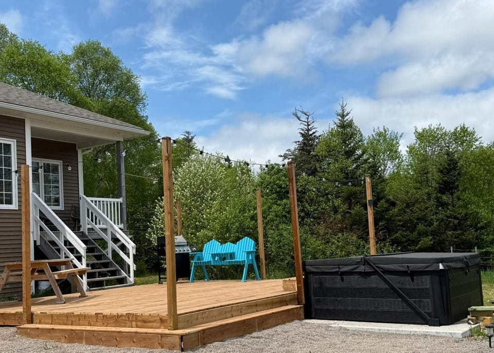 Deck outside, with lounge area, hot tub, ocean view. 
