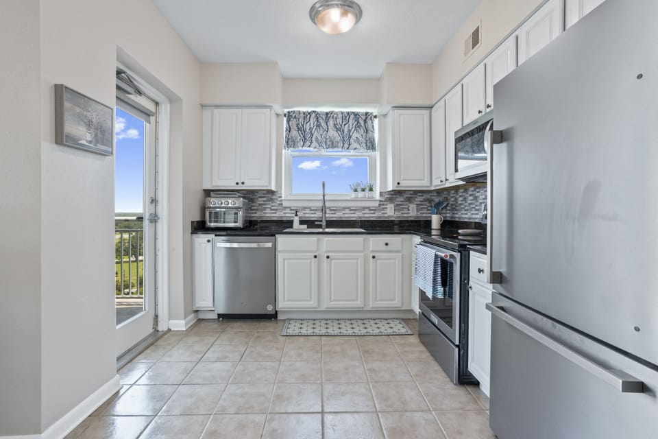 Kitchen has a door that leads to the balcony