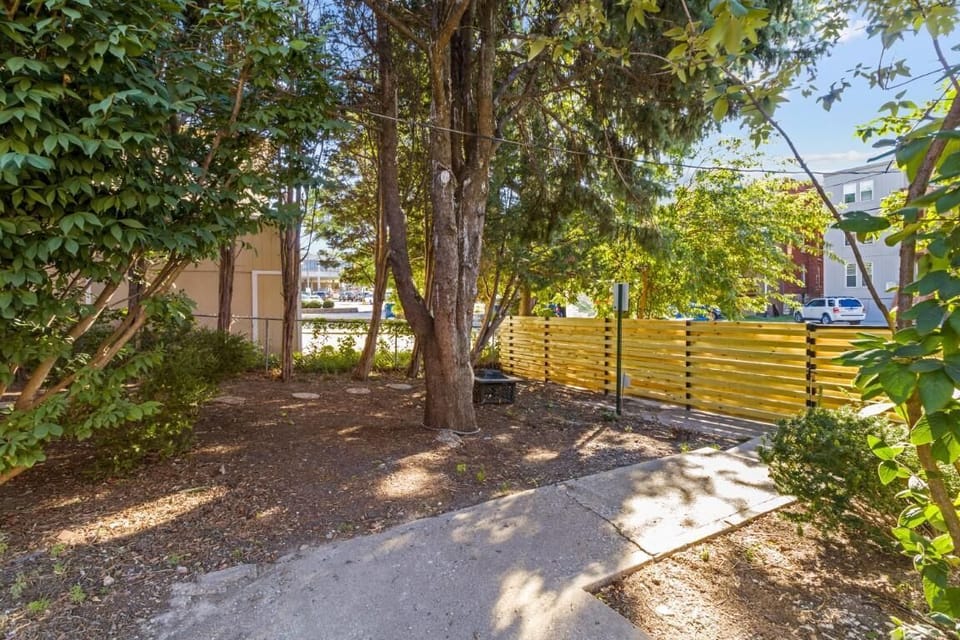 Tree-lined backyardoffering quiet outdoor space and added privacy around this beautifully preserved 3-story historic home.