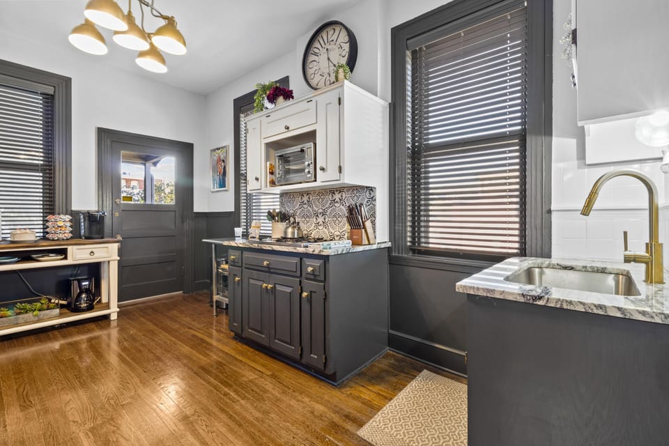 Charming, historic-style kitchen with modern updates, ample counter space, and rich wood floors—perfect for preparing meals before heading to Crown Center or hopping on the KC Streetcar.