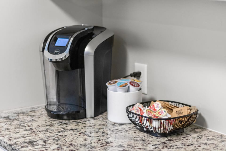 Enhanced coffee bar with Keurig, drip, french press and pour over brewing options to kickstart your mornings.
