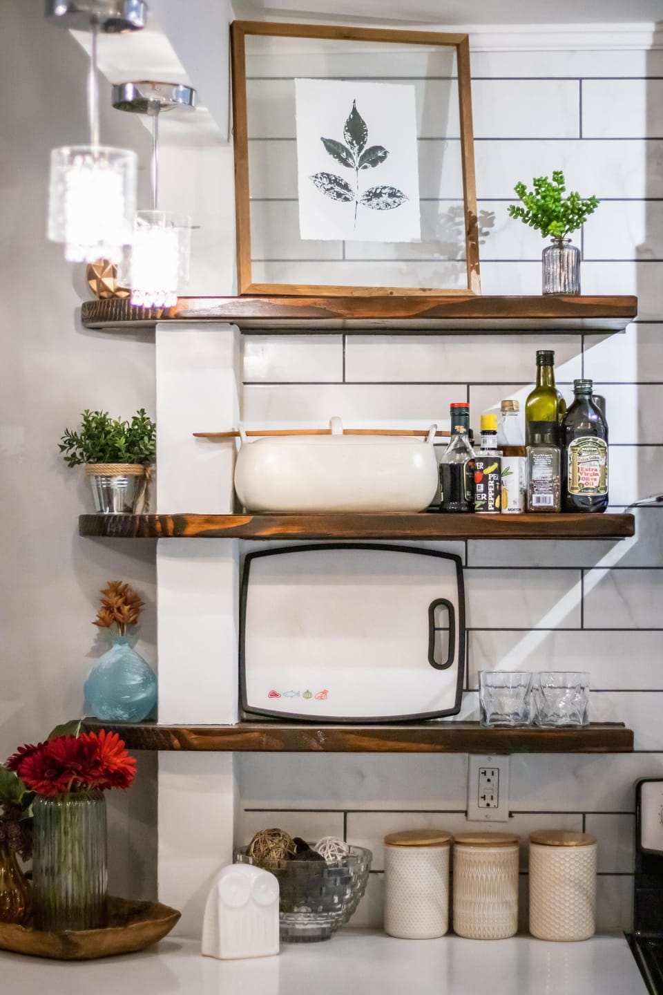 Enjoy a fully stocked kitchen with bright lighting, open shelving, and a modern farmhouse aesthetic ideal for guests who love to cook.