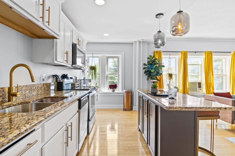 Bright, fully equipped kitchen with ample counter space and an open flow into the living area.