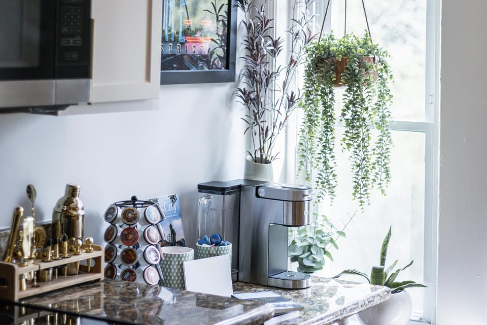 Dedicated coffee and beverage station with coffee grounds, creamer, and multiple brew options, ideal for mornings before strolling to the Plaza or hopping on the KC Streetcar.