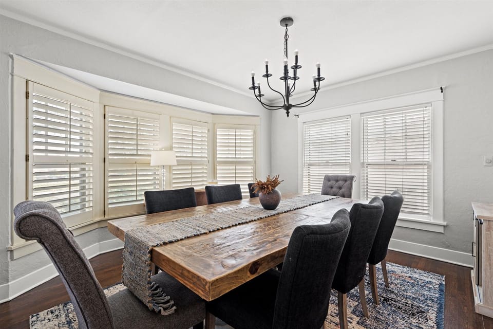 A large dining room table has ample seating for a group of 8