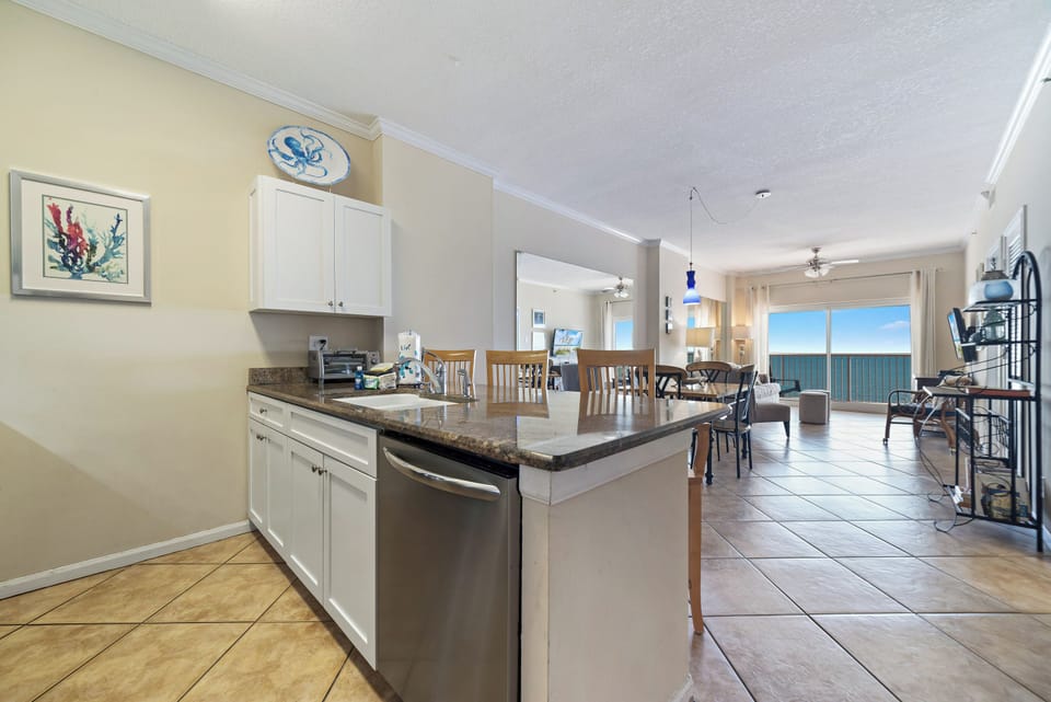 A tidy and functional kitchen countertop. This organized space, complete with coffee makers, a toaster, and a paper towel holder, makes everyday tasks a breeze.