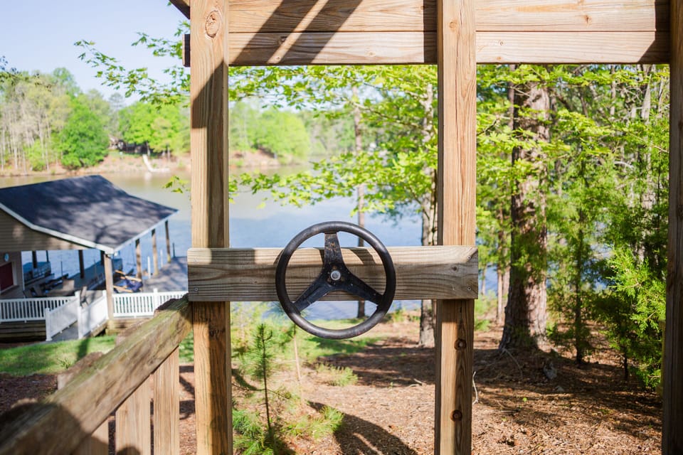 Water view with steering wheel in the kids play boat