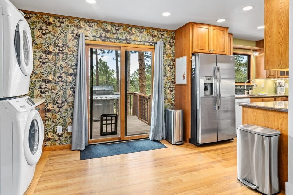 Laundry nook and kitchen with door to the upper back deck.
