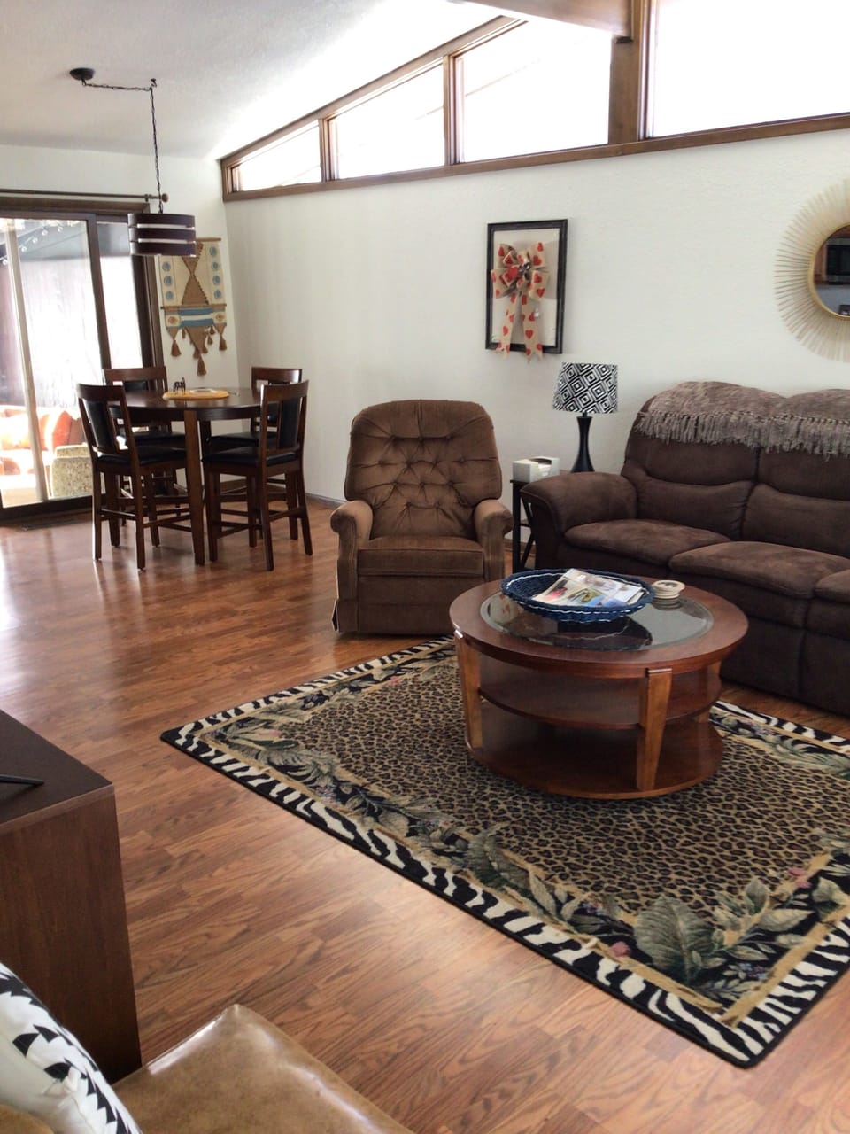 Open area living room, dining room, and kitchen with slider to screened porch.