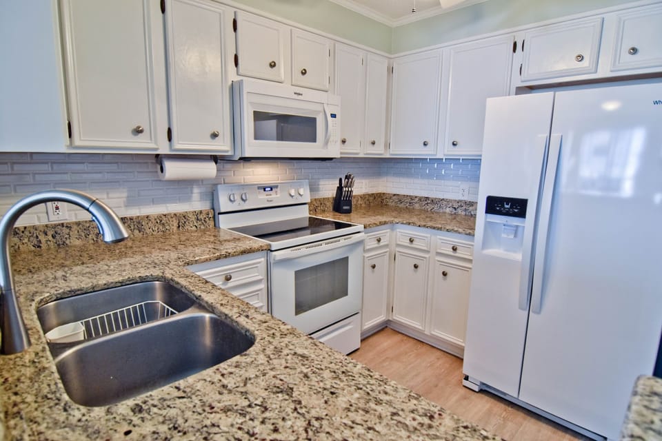 Granite countertops and every utensil you can possibly need.