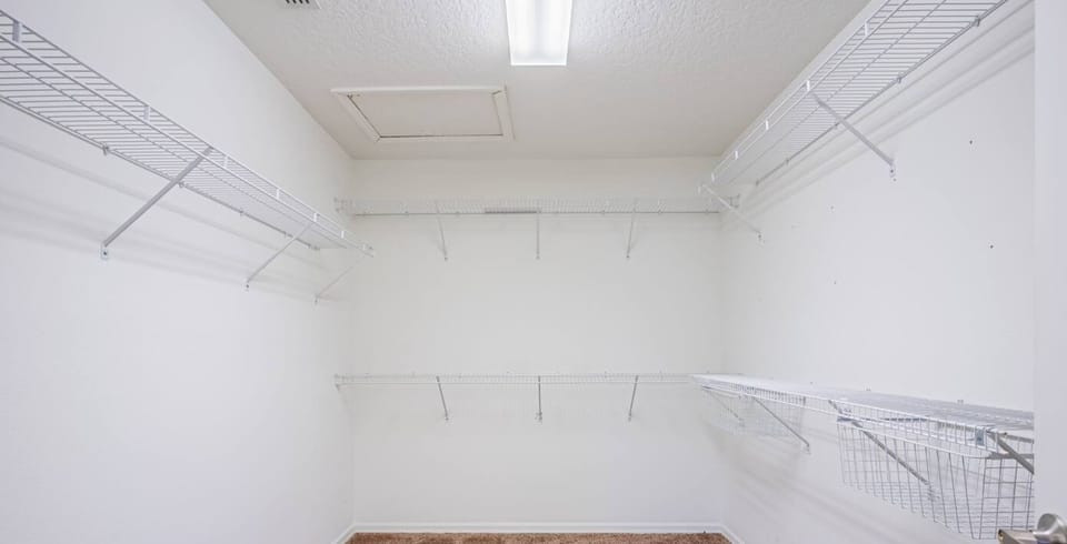 A spacious closet that offers plenty of room for all your wardrobe essentials and more.