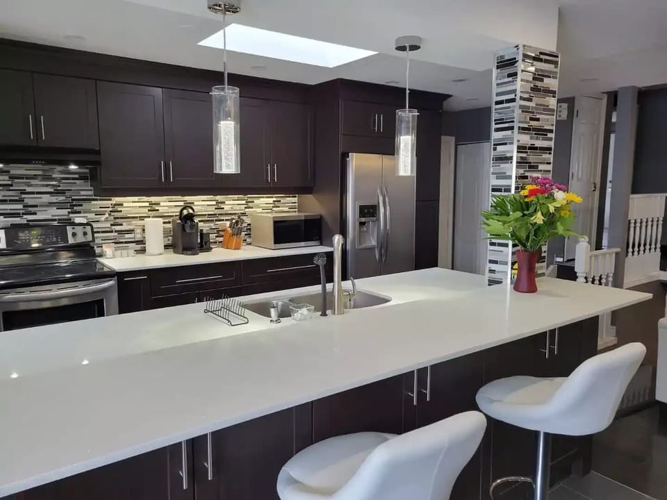 Marble kitchen island with bar stools.