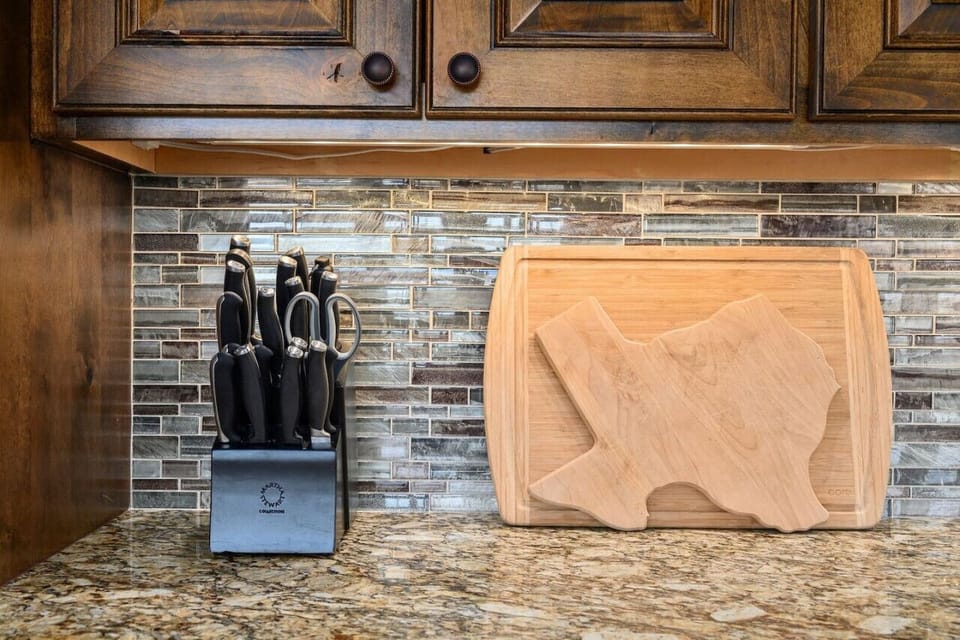 Prep family meals with ease—quality kitchen knives and thoughtful details in the Lakeshore Haven kitchen near Lake Travis in Spicewood, TX.