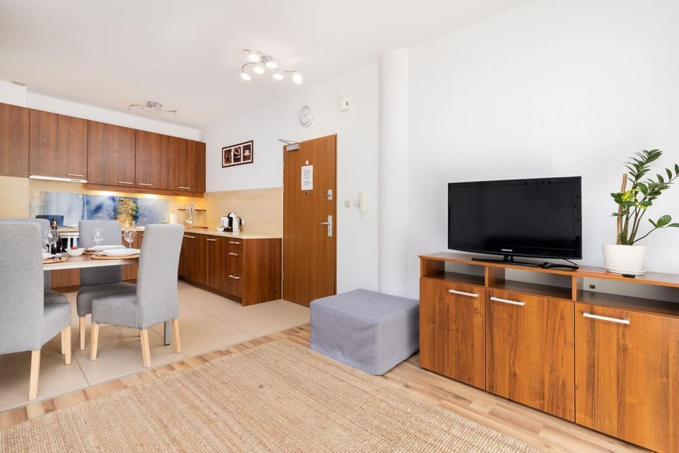 Open-plan living area with a sofa and dining space.
