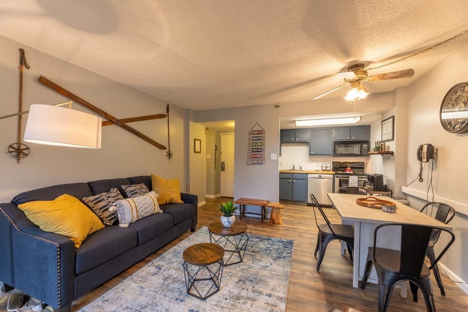 Living room with Fireplace, Smart TV, comfortable chairs, brad new sleeper sofa, coffee table, dining table.