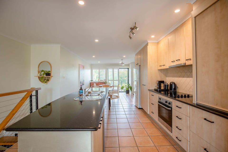 The kitchen space features a breakfast bar perfect for slow holiday-mode mornings.