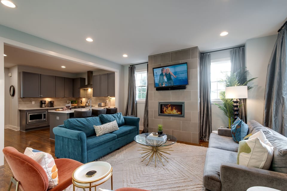 2nd Floor: Living room with smart TV, electric fireplace, bar cart, and multiple lounge areas.