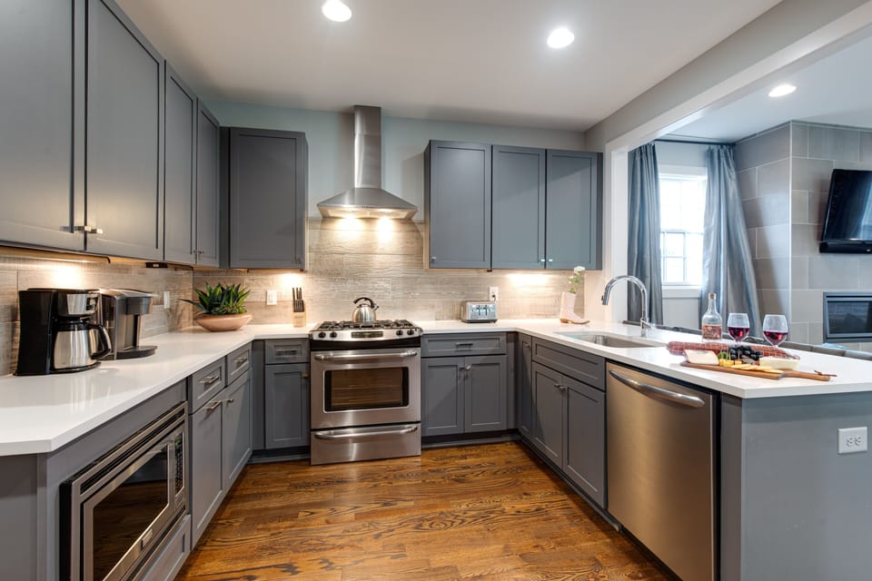 2nd Floor: Fully equipped kitchen with stainless steel appliances and breakfast bar seating.