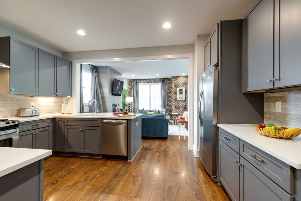 2nd Floor: Fully equipped kitchen with stainless steel appliances and breakfast bar seating.