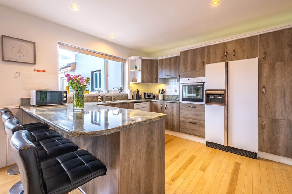 Spacious kitchen is fully equipped to make it a home from home experience. 