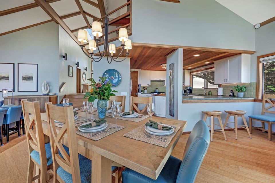 Spacious kitchen with ample counter space. Nook between kitchen and back deck holds extra chairs for the dining table to seat up to 8.