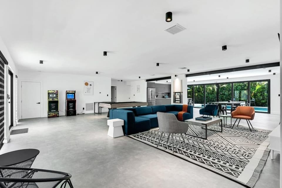 "Expansive open-concept space with modern kitchen, stylish lounge, and indoor-outdoor flow. This luxury vacation rental offers contemporary design perfect for entertaining families and groups. Resort-style Florida living at its finest!"