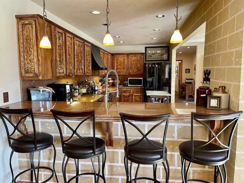 Additional seating for four at kitchen bar open to living area.