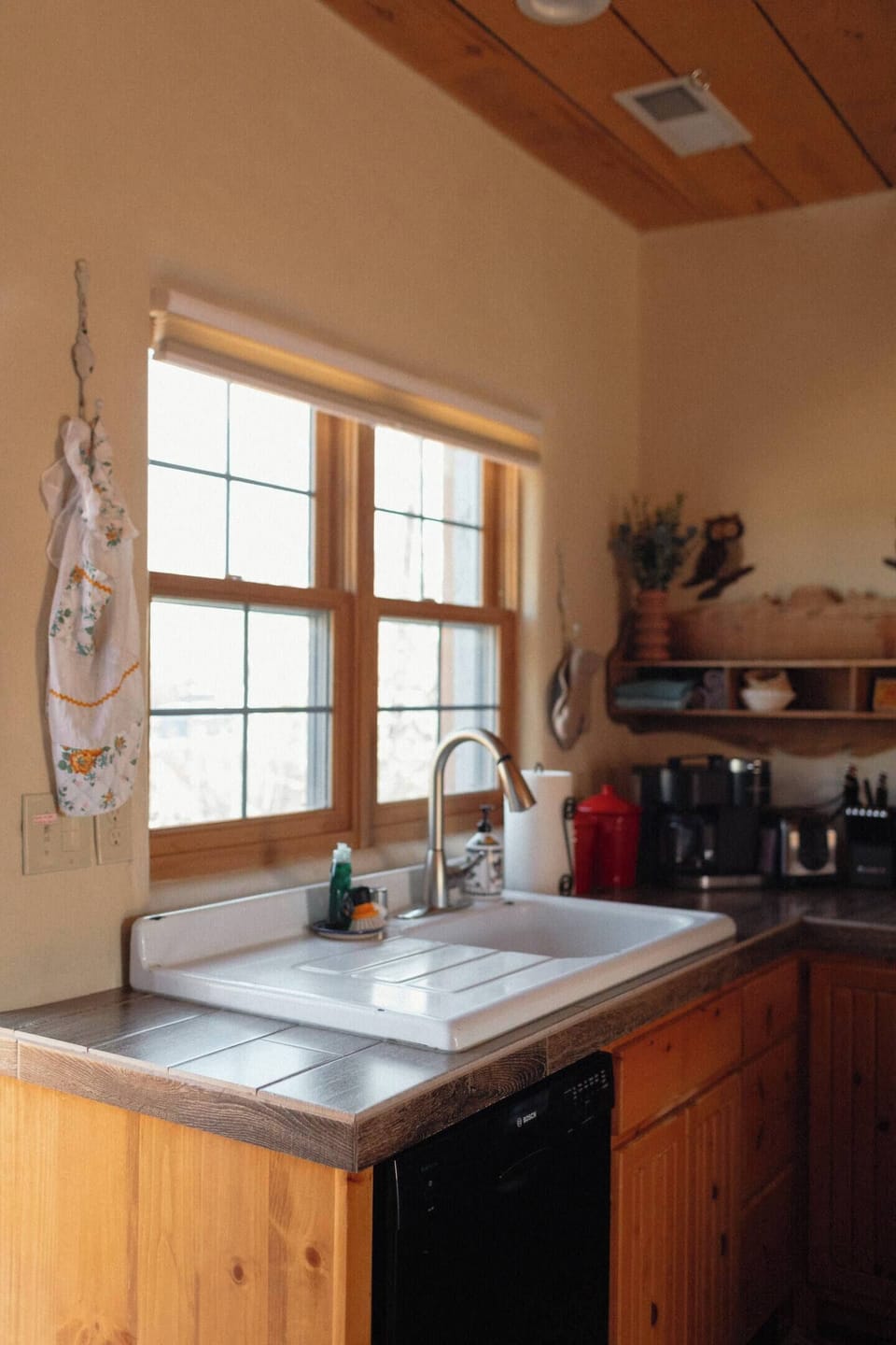 The kitchen window looks out to a grassy park across the street