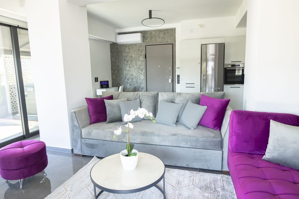 Premium quality sofas and floor to ceiling windows throughout the living room.