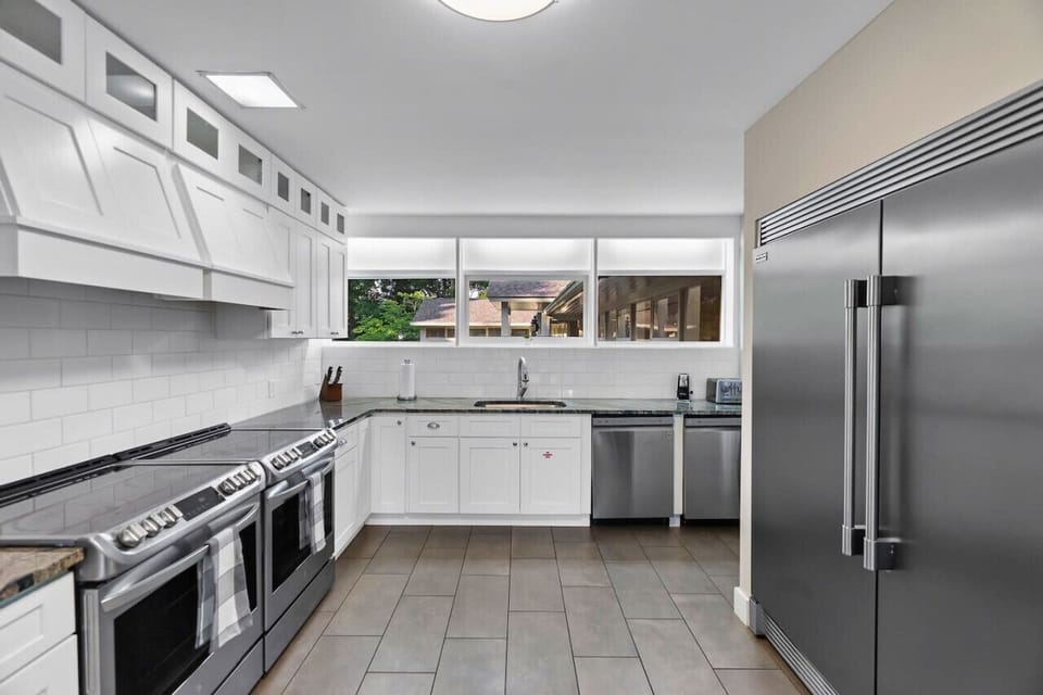 Large kitchen with 2 stoves and large refrigerator/freezer