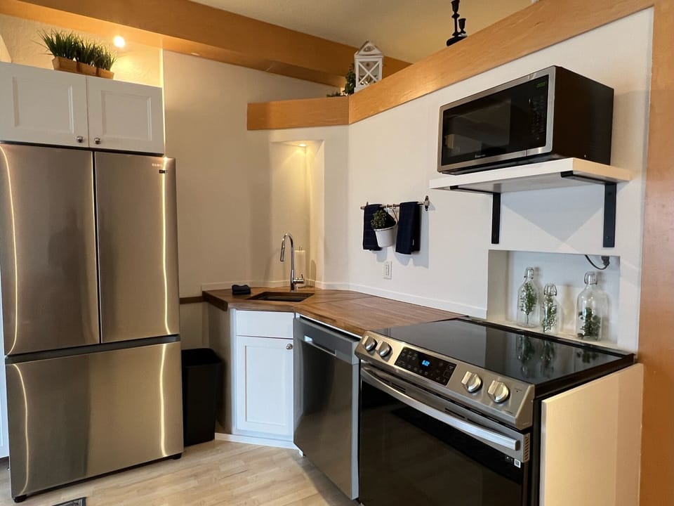 Full-size stainless steel kitchen appliances.