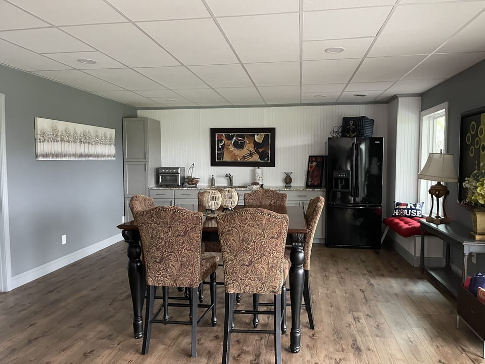 Lower level kitchen and dining accessing patio, hot tub, and pool.