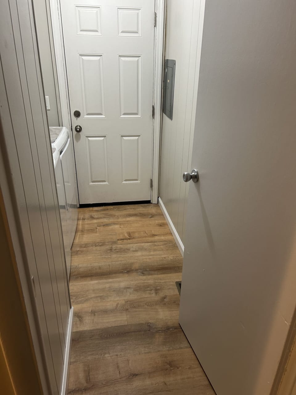 Laundry with rear entrance off driveway.