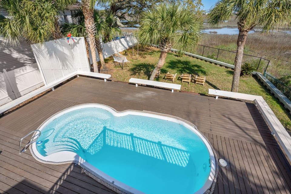 Heart-shaped pool and sun deck at The Gritz Carlton, a 3-bedroom Cherry Grove vacation rental