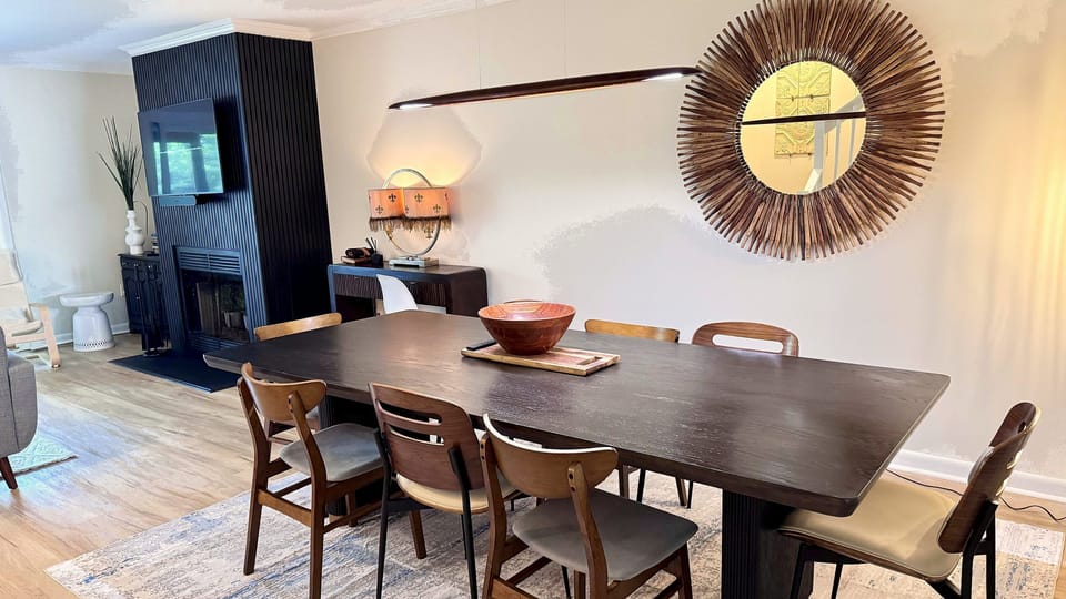Dining table seats 8 — open-concept living, Smart TV, Sonos surround sound, and flow to the screened porch. Perfect for group meals.