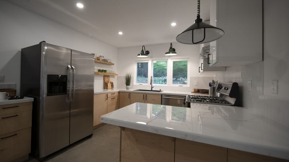 Bosch gas range, Thermador dishwasher, hidden microwave, coffee station.