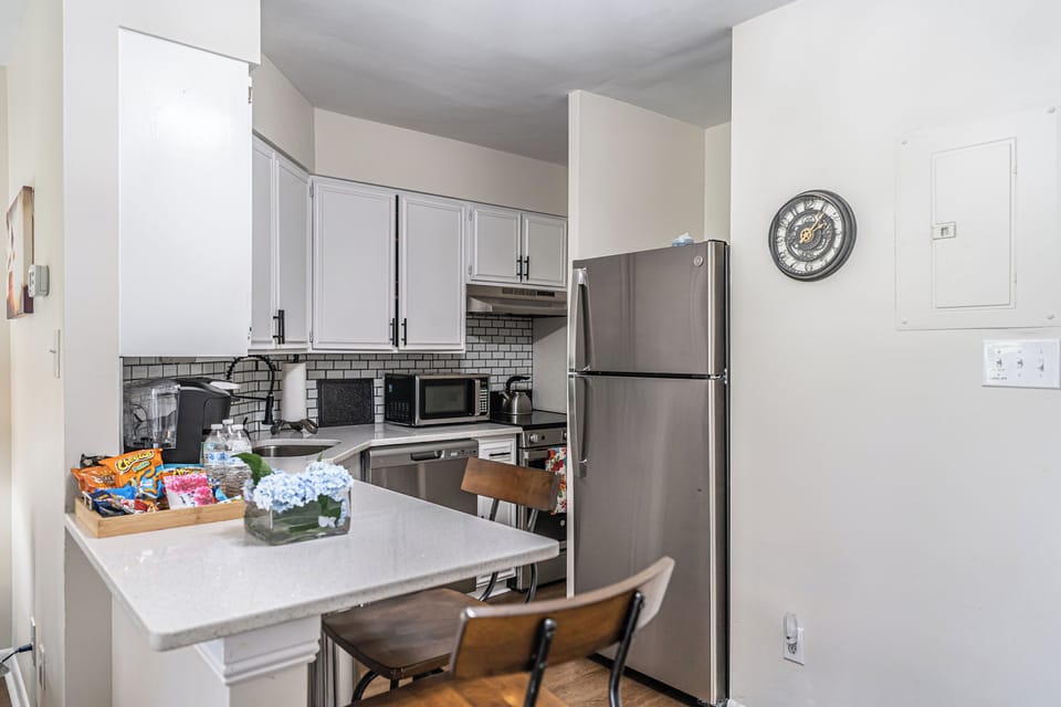 Fully-equipped kitchen with brand new stainless steel appliances & dining area