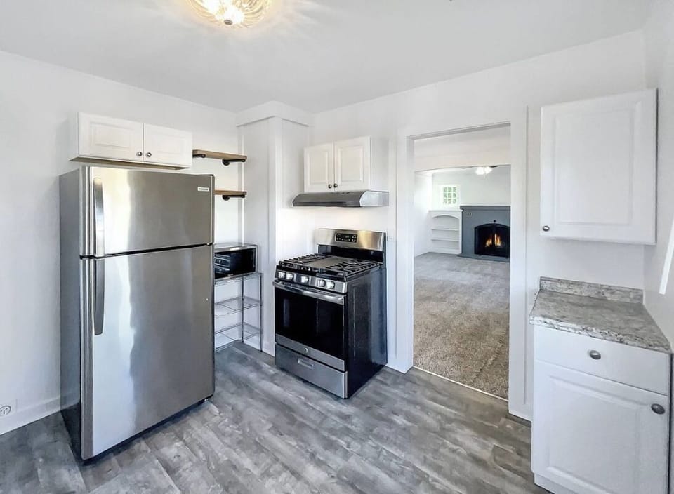 Kitchenette area includes fridge, gas oven/stove, microwave, portable dishwasher