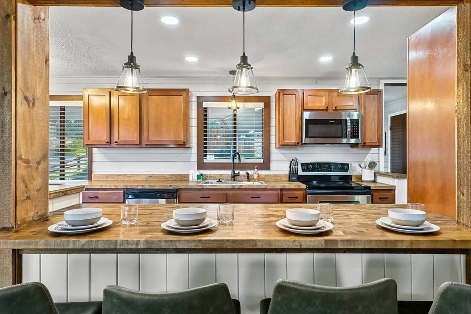The brightly lit open kitchen and dining area is fully stocked for easy living