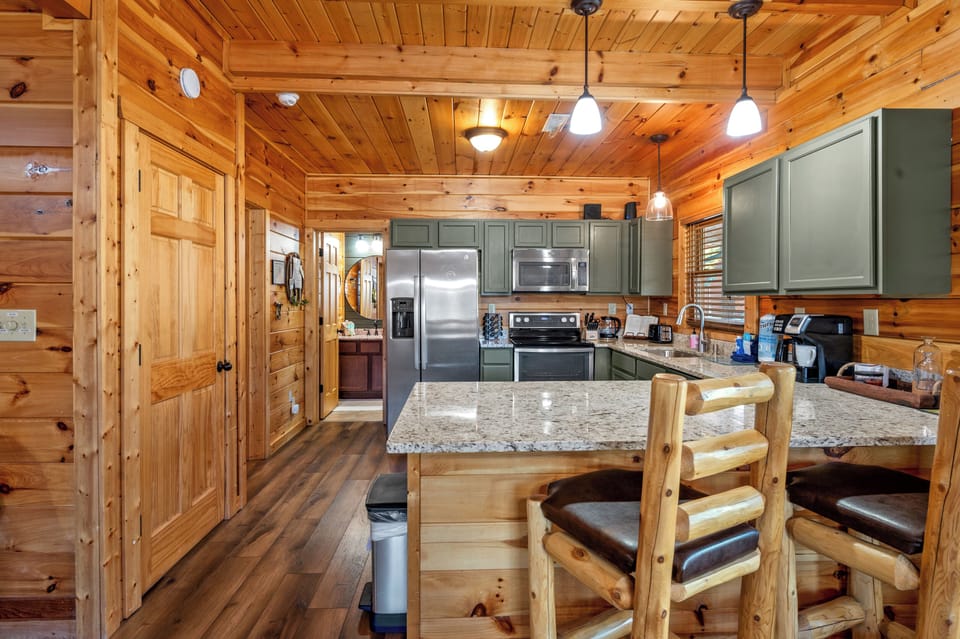 Pull up a stool to the granite countertop in your Sevierville mountain cabin