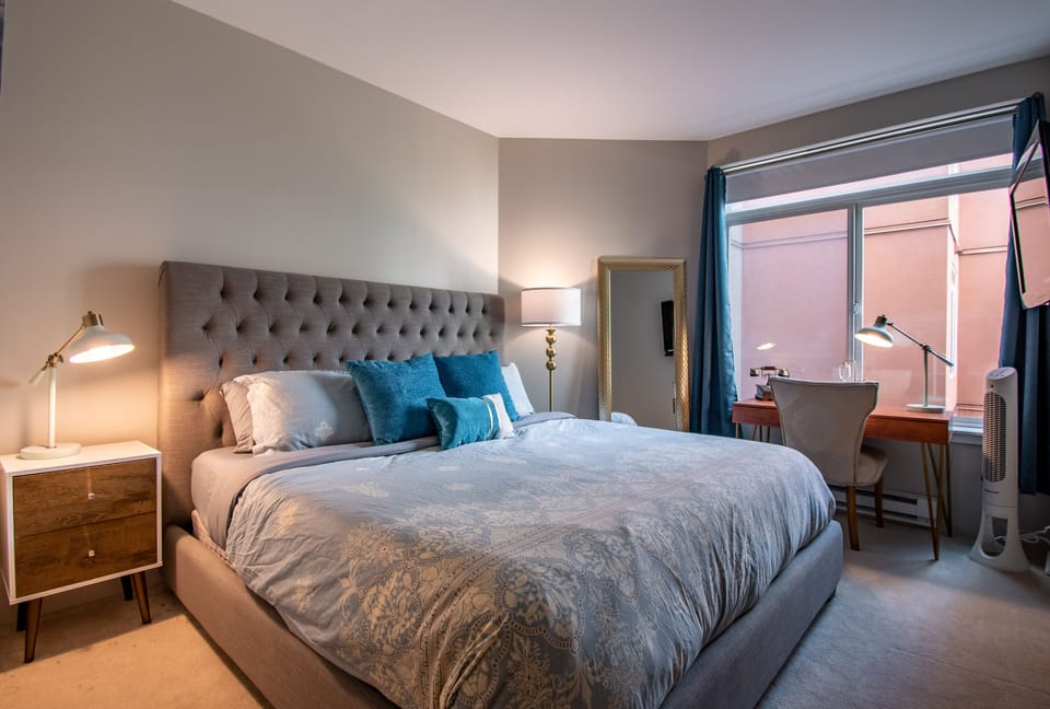 Master Bedroom with a memory foam king mattress, walk-in closet and 55" tv